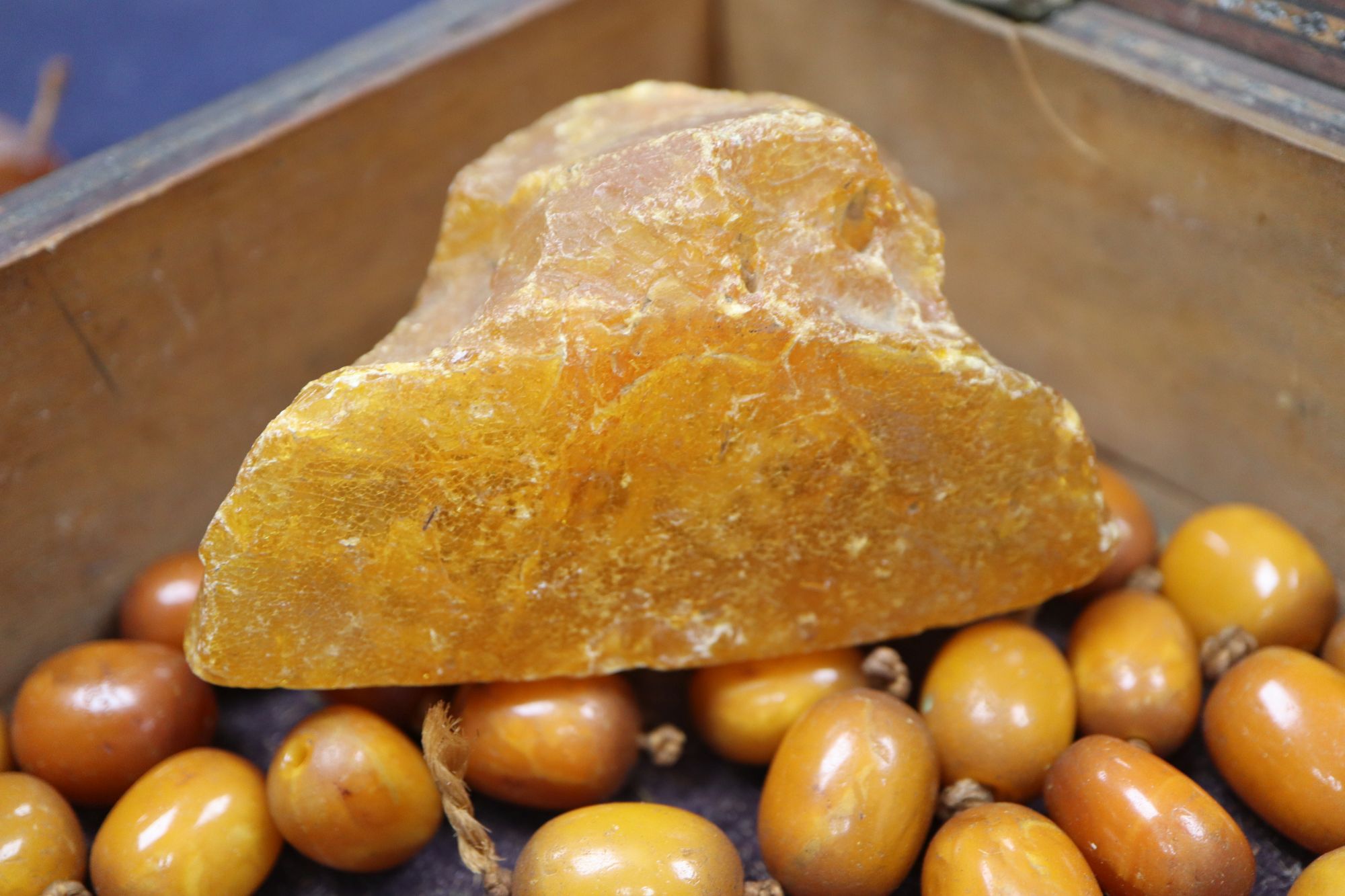 An amber necklace(a.f.) gross 85 grams, four assorted amber pebbles, 528 grams, a carved amber pendant